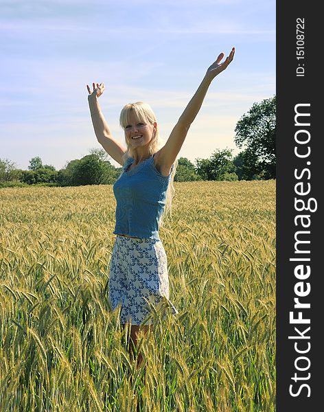 Blond woman in field of wheat