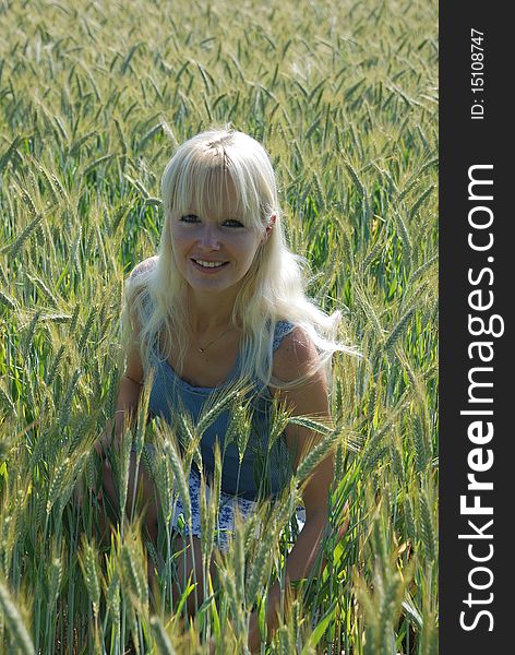 Blond woman in field of wheat