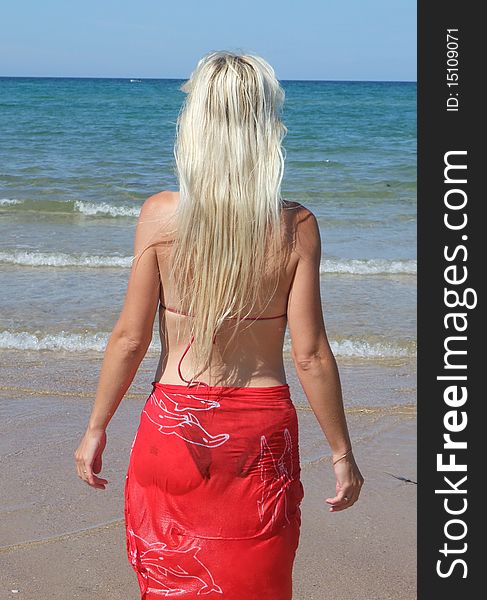 Woman at beach with red cloth