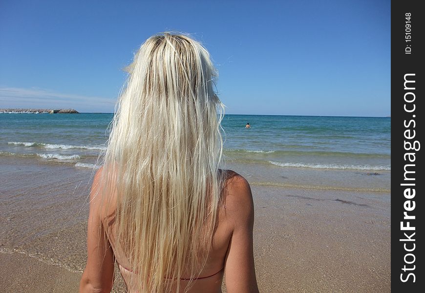 Woman at beach on blue sky