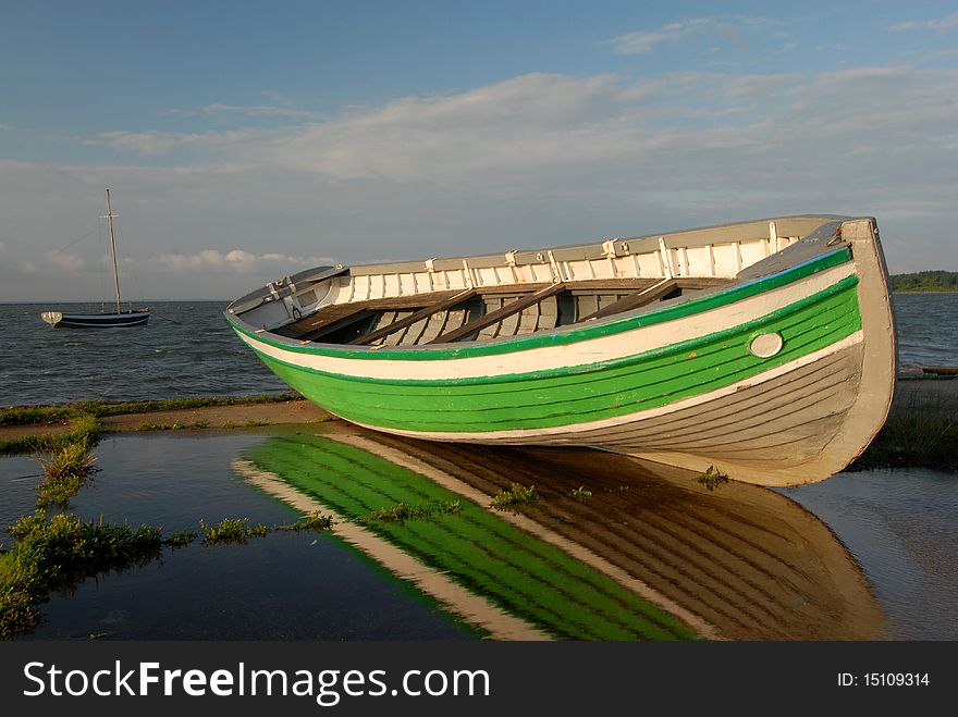 Color boat ashore against the sea