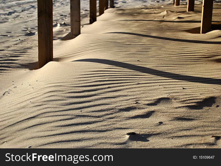 Waves on the sand under a building on a beach. Waves on the sand under a building on a beach