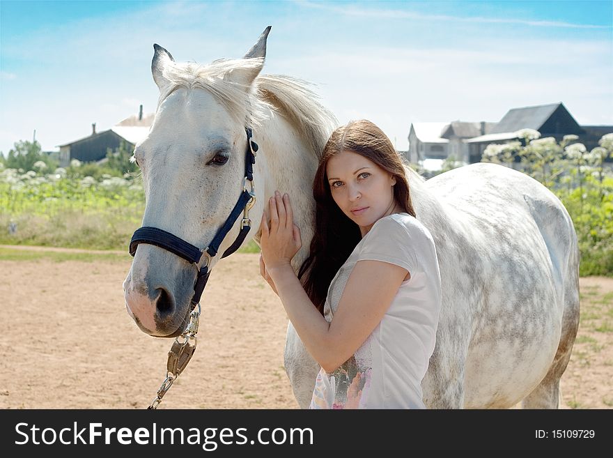 Beautiful woman and white horse at rural area. Beautiful woman and white horse at rural area