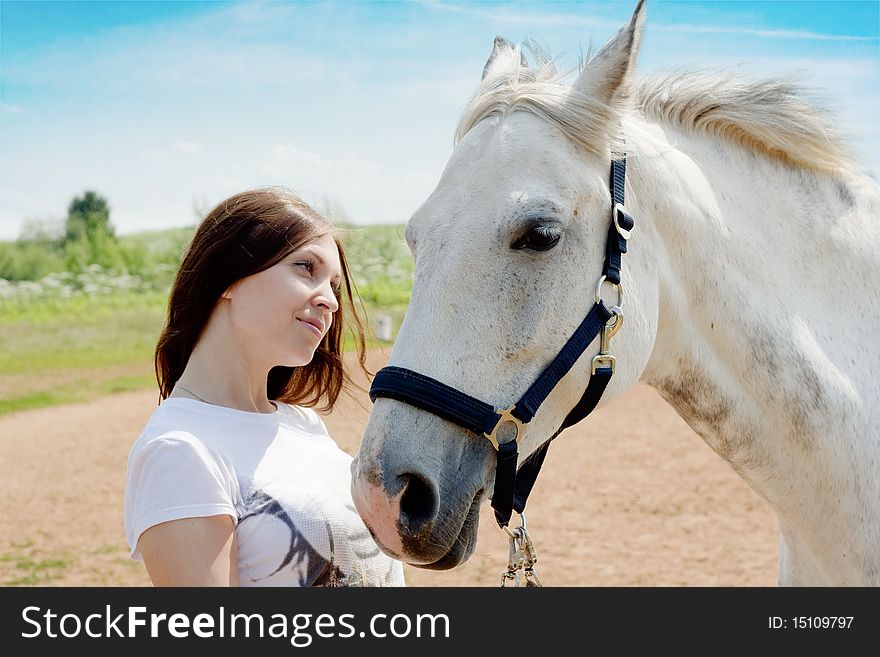 Beautiful woman and white horse at rural area. Beautiful woman and white horse at rural area