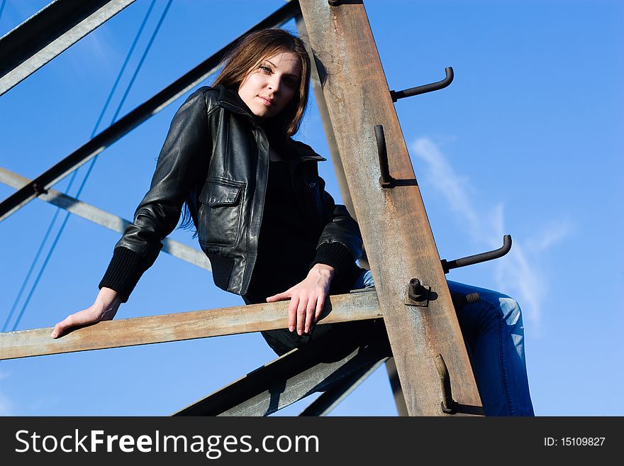 Beautiful woman climbing on electrical tower. Beautiful woman climbing on electrical tower