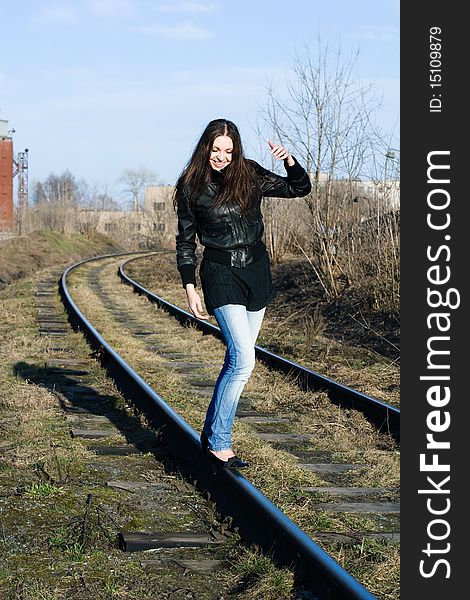 Portrait of a beautiful laughing female model on a railway track. Portrait of a beautiful laughing female model on a railway track