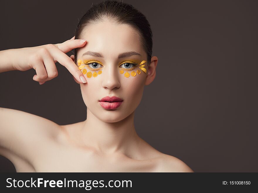 Spa portrait of a young woman. Flowers on her face. The concept of skin and body care. Perfect skin health