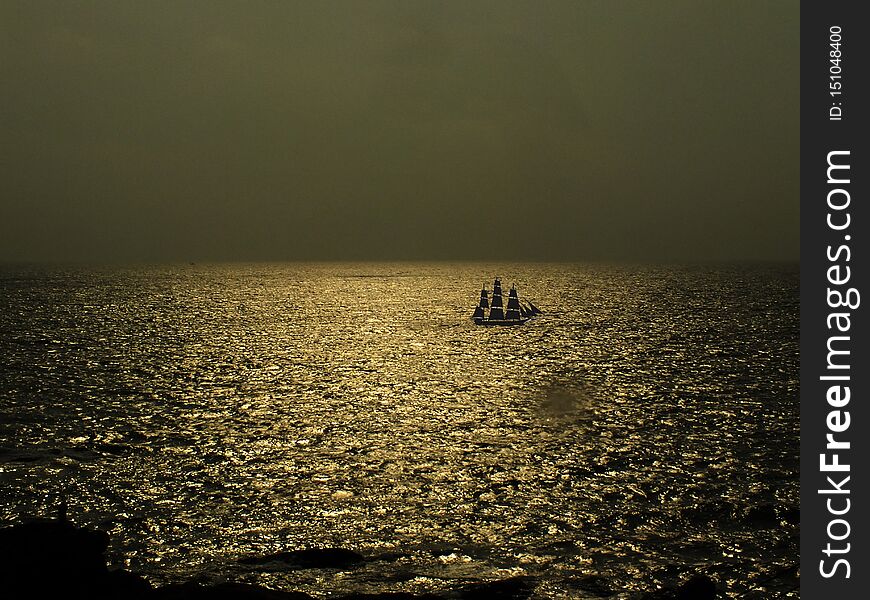 View of Sea Ocean with Golden Sea Water with Boat during sunset sunrise