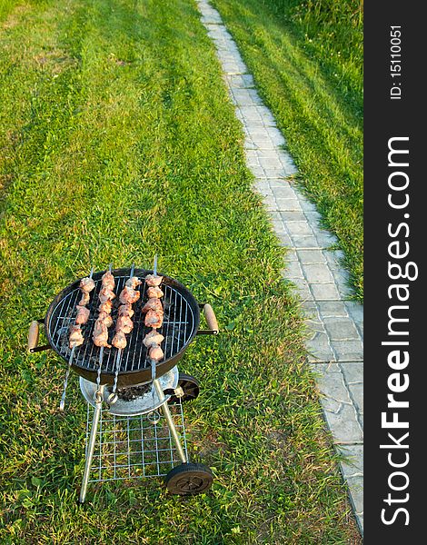 Meat preparation on a barbecue on the nature in the open air