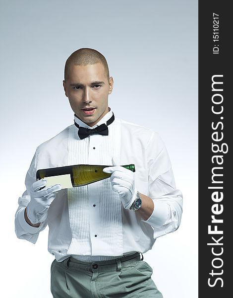 Cool wine waiter holding a bottle of white wine. Cool wine waiter holding a bottle of white wine
