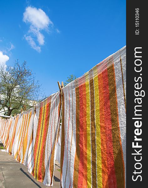 Photo of towels that hang on the rope against the sky