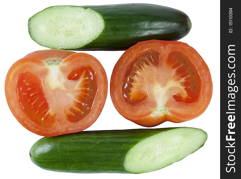 Tomatoes and cucumber are cut on half on white background