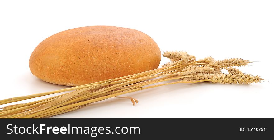 Bread and wheat on a white background. Bread and wheat on a white background