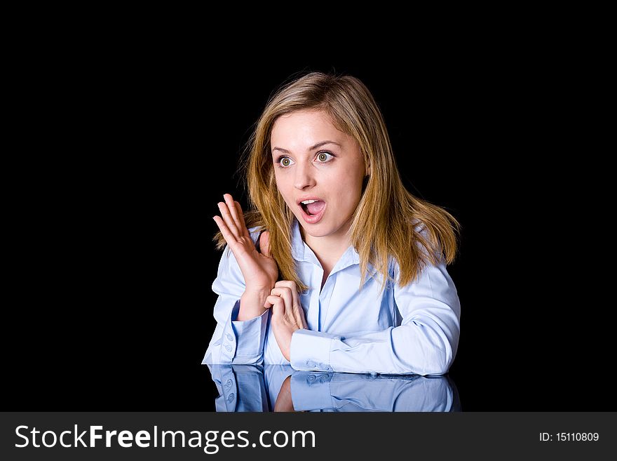 Young attractive businesswoman, surprised by something, studio shoot isolated on black background. Young attractive businesswoman, surprised by something, studio shoot isolated on black background