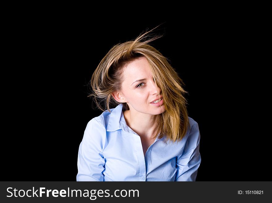 Young attractive female plays with her hairs, studio shoot isolated on black background