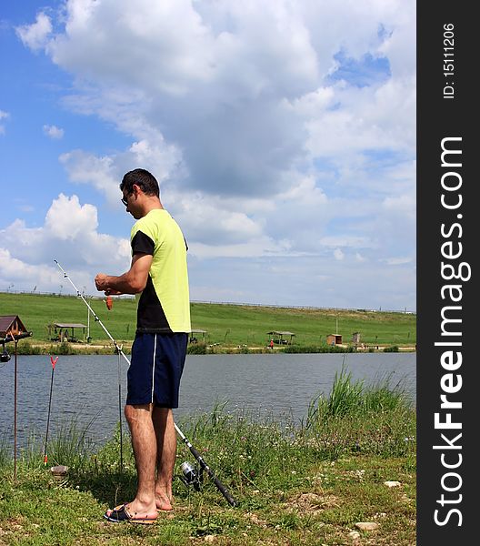 Young boy putting bait in the fishing line. Young boy putting bait in the fishing line