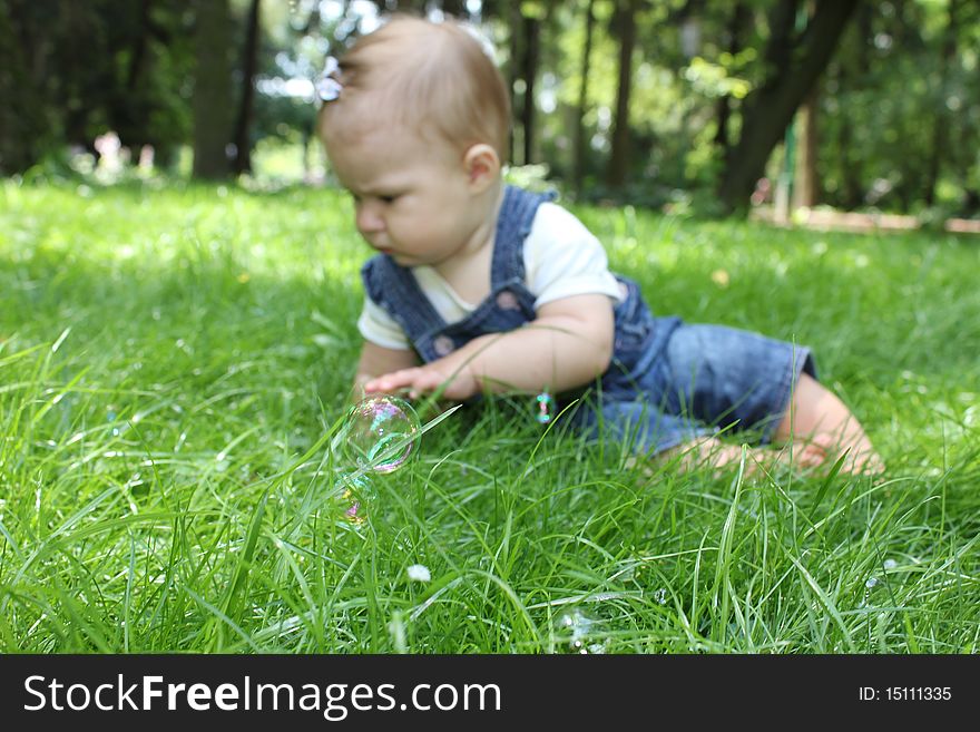 Little girl on the green grass