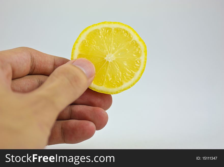 A lemon piece with hands on