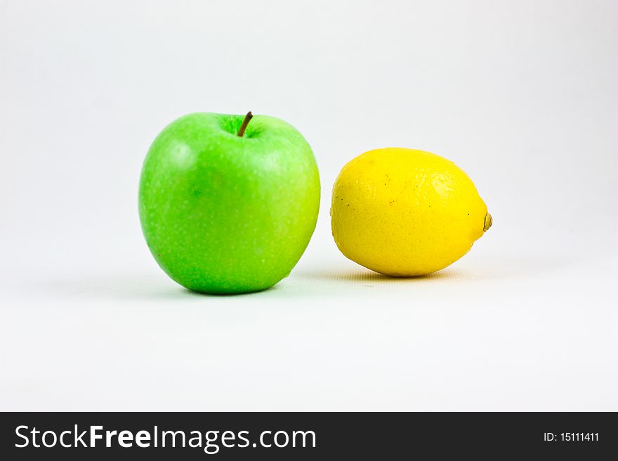 A fresh apple and lemon showing together. A fresh apple and lemon showing together