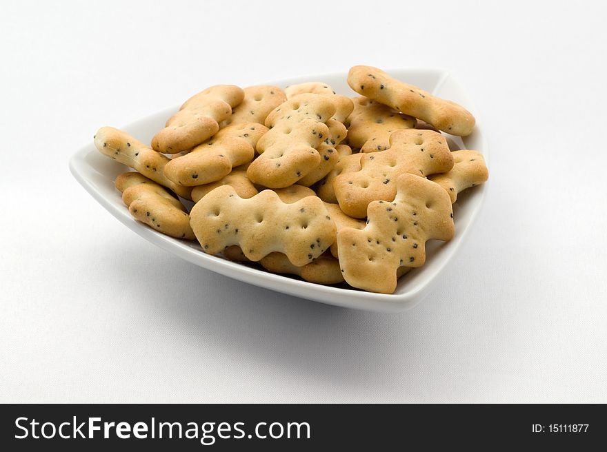 Wheat crackers with poppy seeds on the white plate