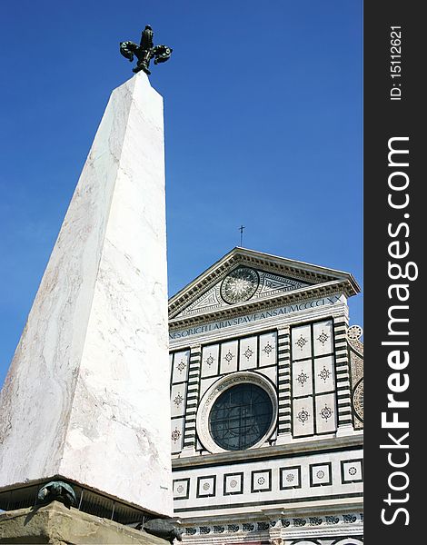 White obelisk in front of a church in florence. White obelisk in front of a church in florence