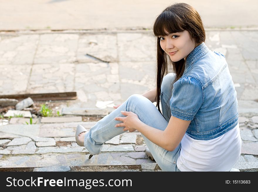 Girl sitting on stairs outdoor