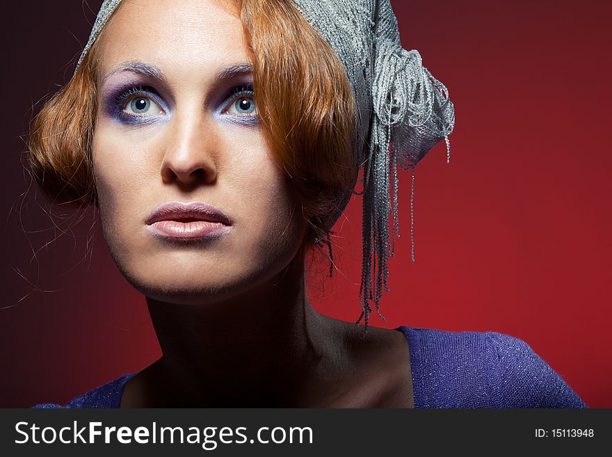 Portrait of attractive retro-style girl in bonnet over red