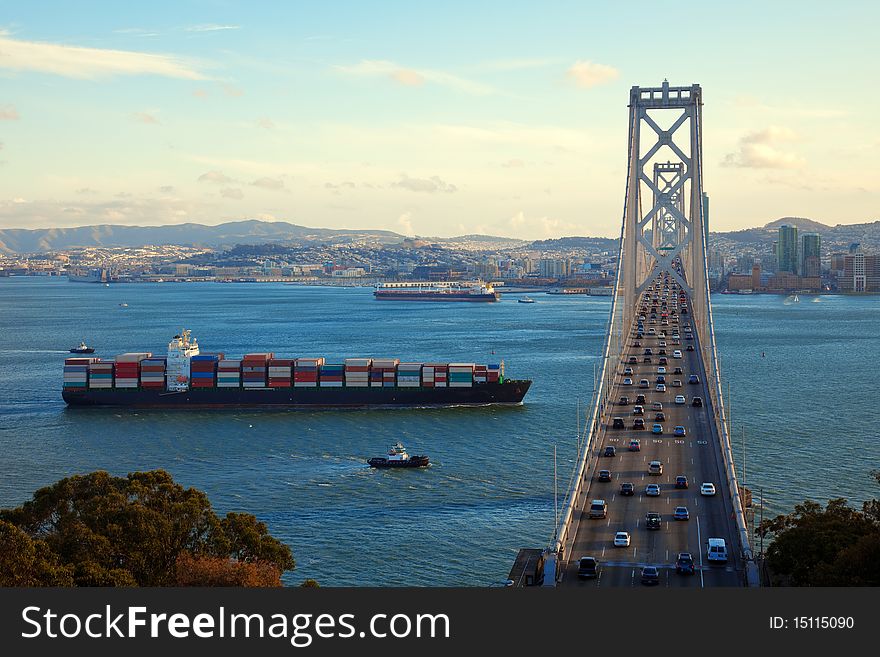 Freight ship passing under Bay Bridge, San Francisco Bay. Freight ship passing under Bay Bridge, San Francisco Bay.