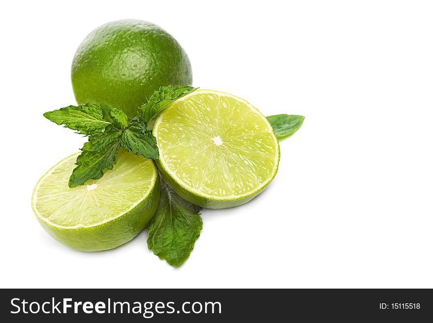 Green limes with mint isolated on white