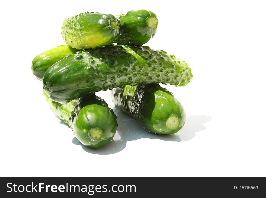 Heap made with cucumbers on a center of image on white background. Heap made with cucumbers on a center of image on white background