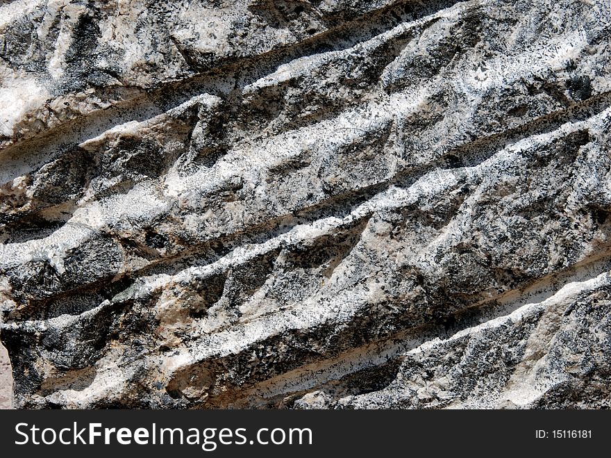 Rocky surface including stripes, ideal as a background or texture. Rocky surface including stripes, ideal as a background or texture.