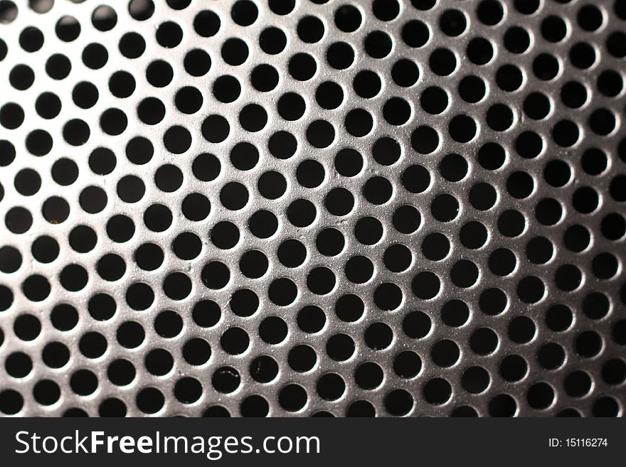 This is a closeup of a speaker cover. This is a closeup of a speaker cover.