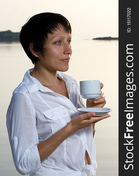 Young Woman Meets Sunrise Drinking Morning Coffee