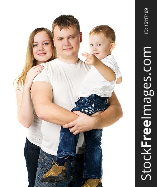 Young parents with son on hands in white T-shirts stand isolated on white,  kid points a finger in the camera. Young parents with son on hands in white T-shirts stand isolated on white,  kid points a finger in the camera