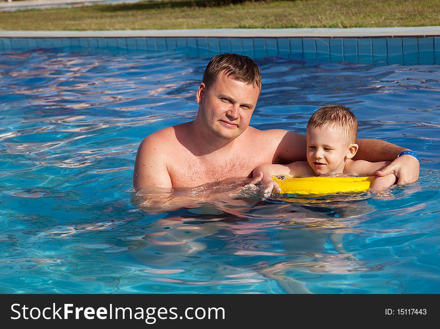 Father and happy son in swimming pool. Father and happy son in swimming pool