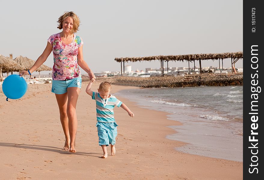 Mother and son running on beach. Mother and son running on beach