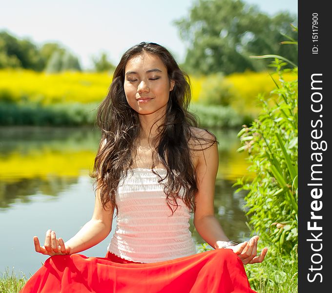 Young Woman Sitting In Park