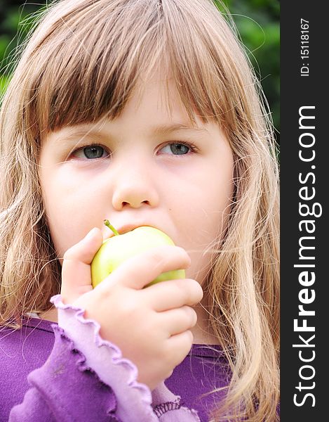 Healthy little girl biting the apple. Healthy little girl biting the apple