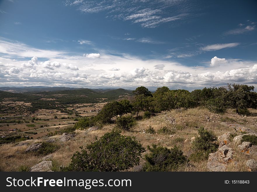 Landscape in north Greece. Clouds and trees in blue sky. Landscape in north Greece. Clouds and trees in blue sky