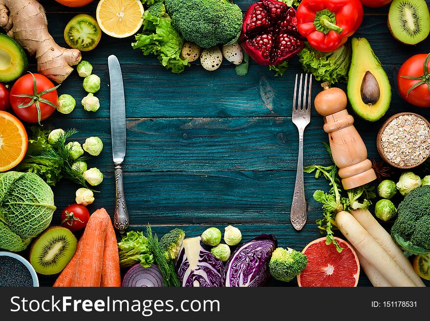 Healthy organic food on a blue wooden background. Vegetables and fruits. Top view. Free copy space