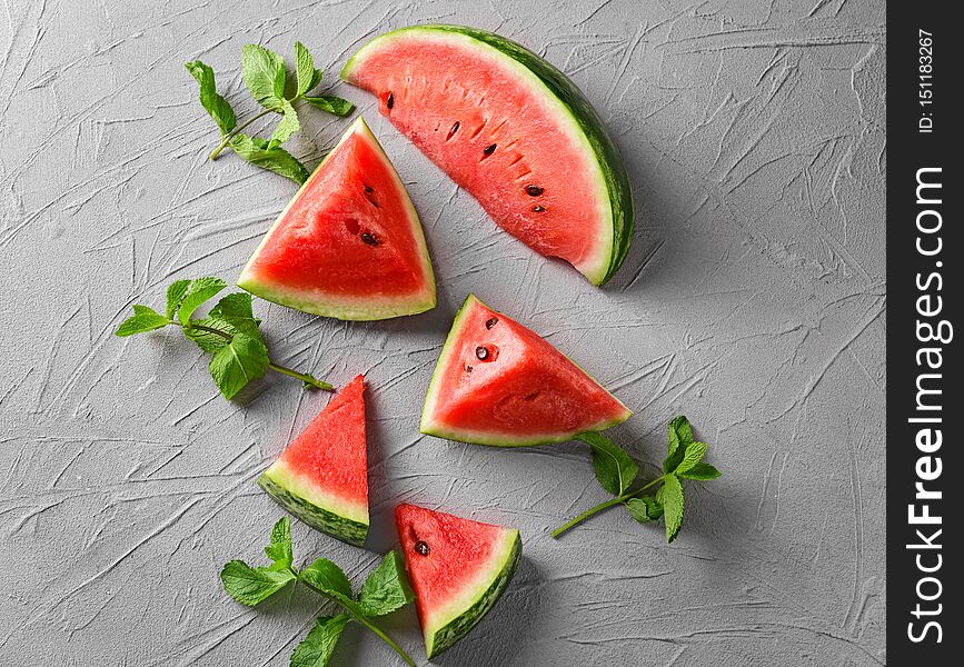 Sweet watermelon slices on grey textured background