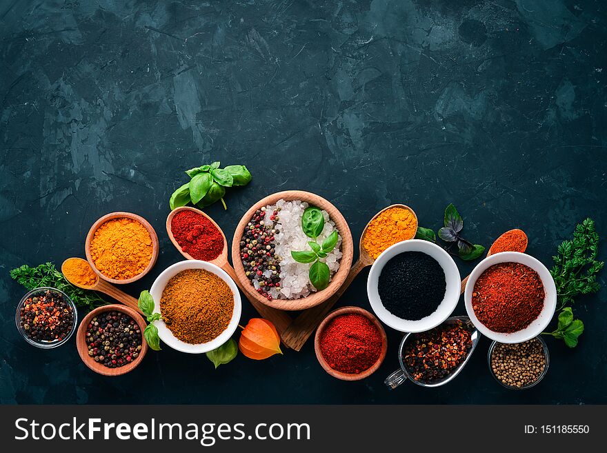 A set of spices and herbs on a stone table. Indian traditional spices.