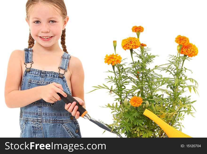 Attractive 5 year old american girl with potted marigold plant and garden tools. Attractive 5 year old american girl with potted marigold plant and garden tools.