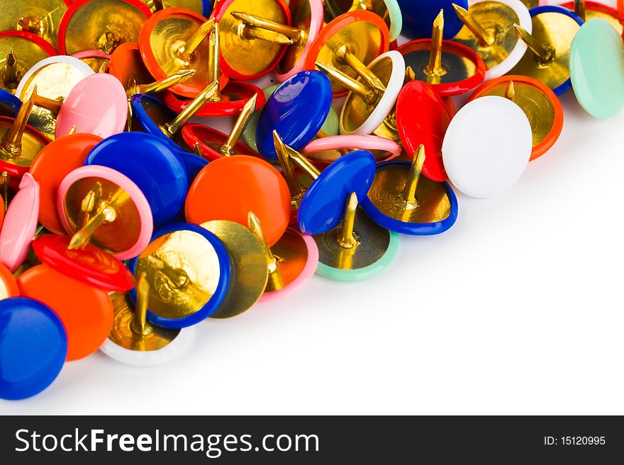 Heap of multicolored pins isolated on white background