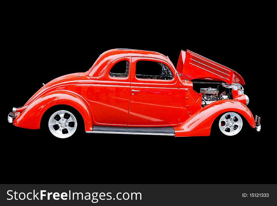 Bright red car isolated on a black background. Bright red car isolated on a black background.