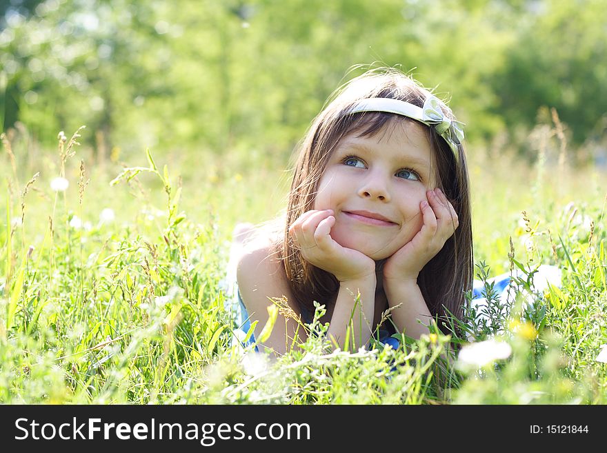 Young beautiful happy girl lays on a grass. Young beautiful happy girl lays on a grass