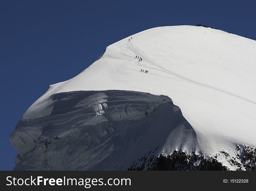 Tourists and sportsmen on the Breithorn mountain in the Swiss Alps. There is snow and in summer as well.