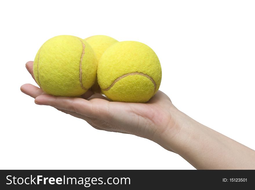 Hand holding three tennis balls in a studio