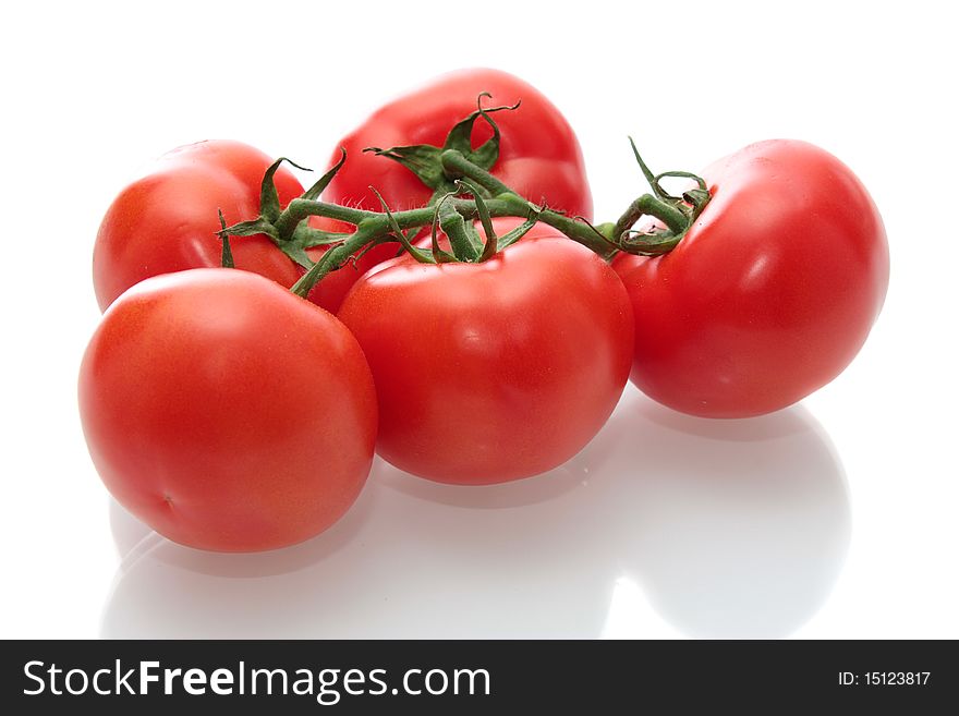 Tomatoes with a branch, on a white background, it is isolated. Tomatoes with a branch, on a white background, it is isolated.