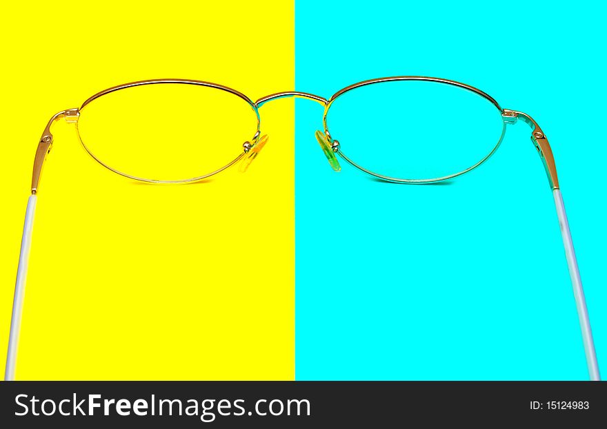 Glasses for eyes on blue and yellow background